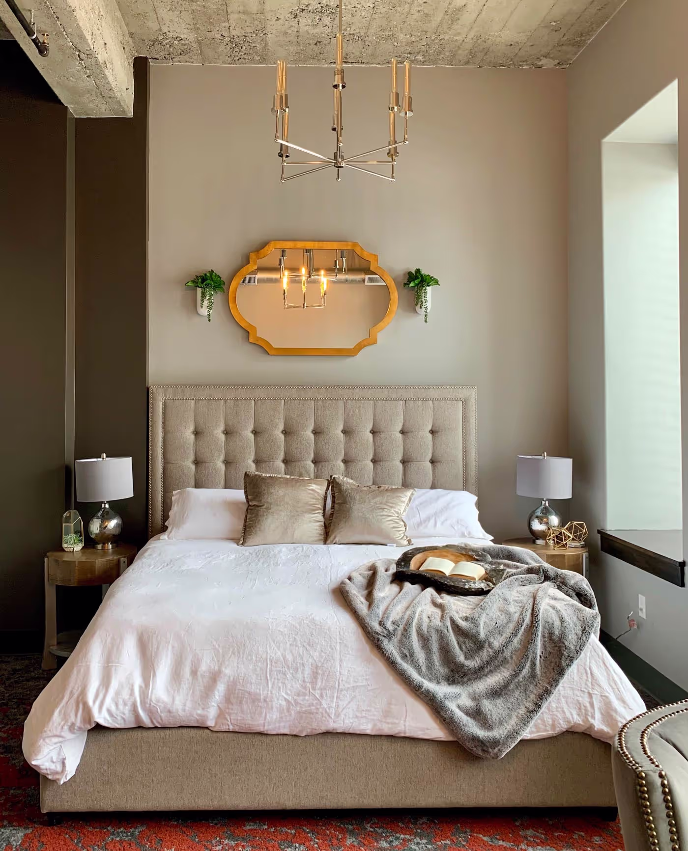 a bedrrom with a bed and a mirror